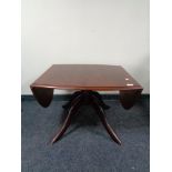 A Stag Minstrel flap sided pedestal coffee table