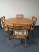 A circular teak G Plan extending table and four chairs