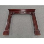 A contemporary mahogany effect fire surround