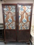 A Victorian mahogany double door cabinet with astral glazed doors