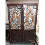 A Victorian mahogany double door cabinet with astral glazed doors