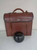 A set of four leather cased Henselite lawn bowls