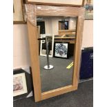 An oak effect flat framed mirror