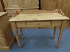 A pine console table fitted a drawer