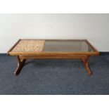 A mid 20th century teak tiled topped and smoke glass coffee table
