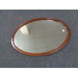 An oval antique mahogany framed mirror