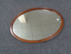 An oval antique mahogany framed mirror