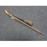 A rustic wooden club and walking stick