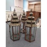 Three metal hexagonal candle lanterns in the form of Chinese pagodas.