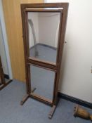 A 20th century stained wood adjustable glass cheval mirror