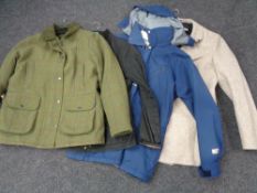 A lady's tweed style jacket together with three other coats