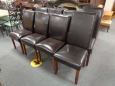 A set of six brown leather dining chairs and a pair of chairs