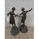 A pair of antique spelter figures on wooden bases