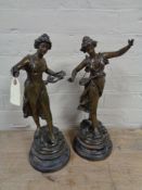 A pair of antique spelter figures on wooden bases