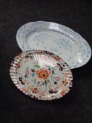 An antique blue and white meat plate together with an Imari patterned plate.