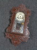 A nineteenth century American wall clock by Ansonia clock company with pendulum and key