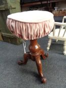 A Victorian mahogany revolving piano stool