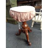 A Victorian mahogany revolving piano stool