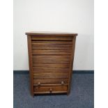 An oak shutter front cabinet fitted internal shelf