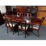 A nine piece Meredew dining room suite comprising cocktail cabinet, oval table with leaf,