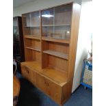 A 20th century teak G Plan bookcase with cupboards beneath