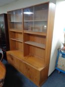 A 20th century teak G Plan bookcase with cupboards beneath