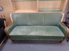 An early twentieth century continental beech framed settee in striped upholstery