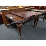 A Victorian mahogany wind out dining table with leaf and winder