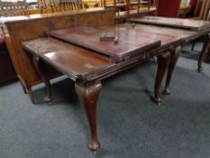 A Victorian mahogany wind out dining table with leaf and winder