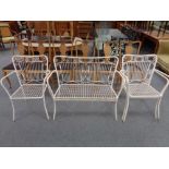 A painted metal two seater garden bench and three matching chairs