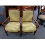 A pair of continental scroll armchairs in yellow upholstery