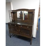 An Edwardian oak mirror backed sideboard