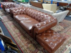 A four piece brown leather Chesterfield lounge suite comprising three seater settee,