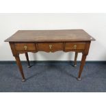 A 19th century oak three drawer side table