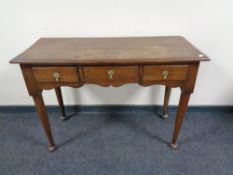 A 19th century oak three drawer side table