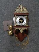 A continental style wall clock with brass pear drop weights