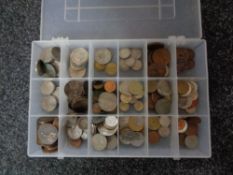 A plastic case of pre decimal British and foreign coins