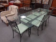 A glass-topped and wrought iron based dining table,