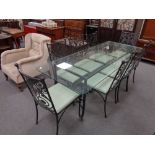 A glass-topped and wrought iron based dining table,