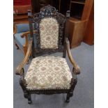 A continental carved oak scroll armchair
