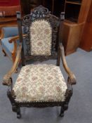 A continental carved oak scroll armchair