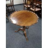 A mahogany tilt topped pedestal occasional table