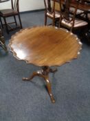 A mahogany tilt topped pedestal occasional table