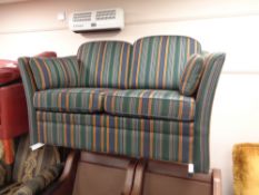 A two seater settee in striped upholstery