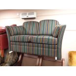 A two seater settee in striped upholstery