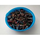 A tub of cast lead and die cast military and other figures