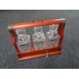 Three cut glass whisky decanters in Tantalus
