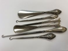 Two silver mounted shoe horns and four similar boot pulls