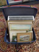 A vintage luggage case containing electric panel heater, pictures, prints, D.