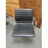 A Vitra Charles Eames designed Alu swivel armchair upholstered in black leather with chrome frame